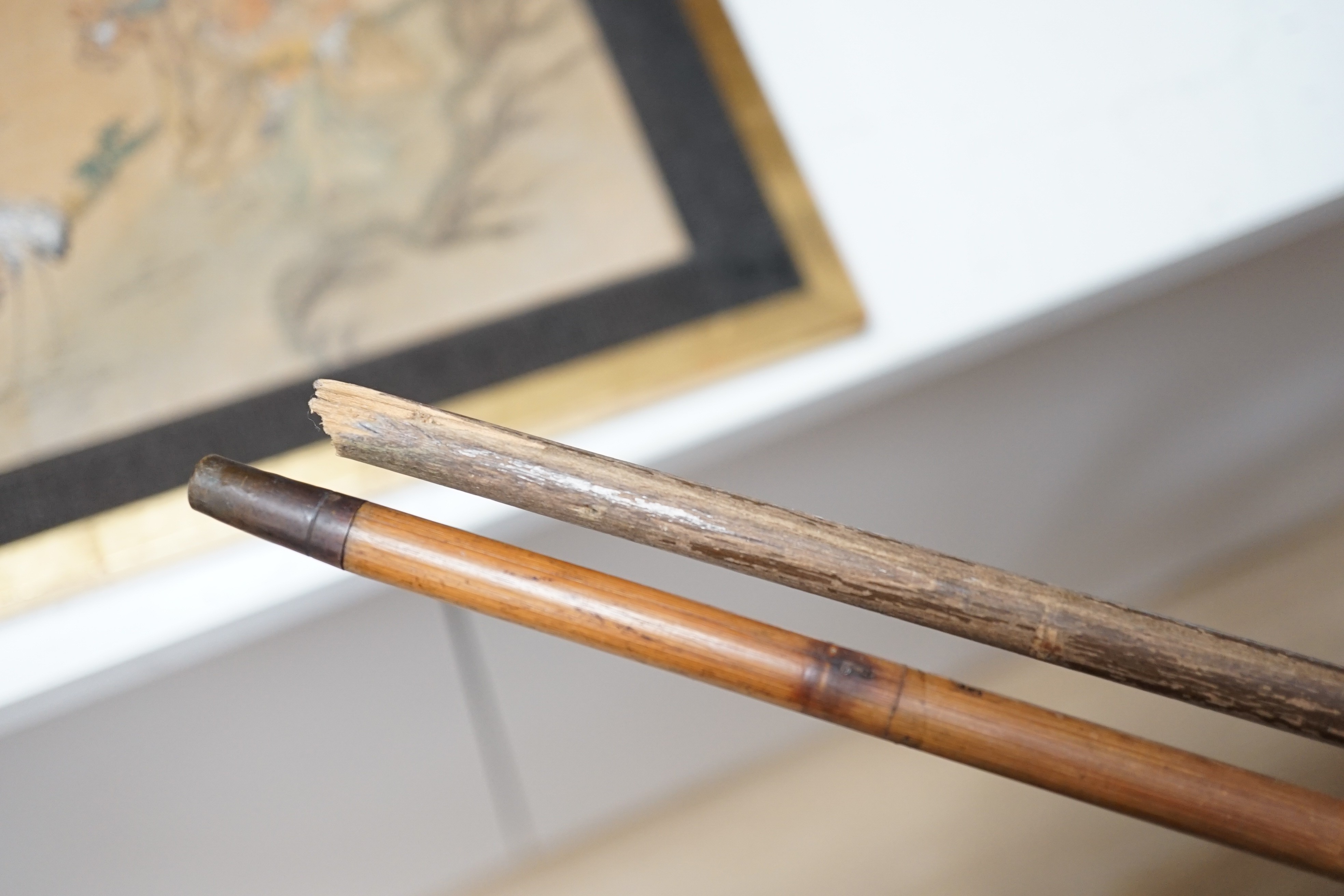 An early 20th century ivory ‘sphinx’ parasol handle, 84cm, together with another gold and iron damascened parasol handle, 62cm